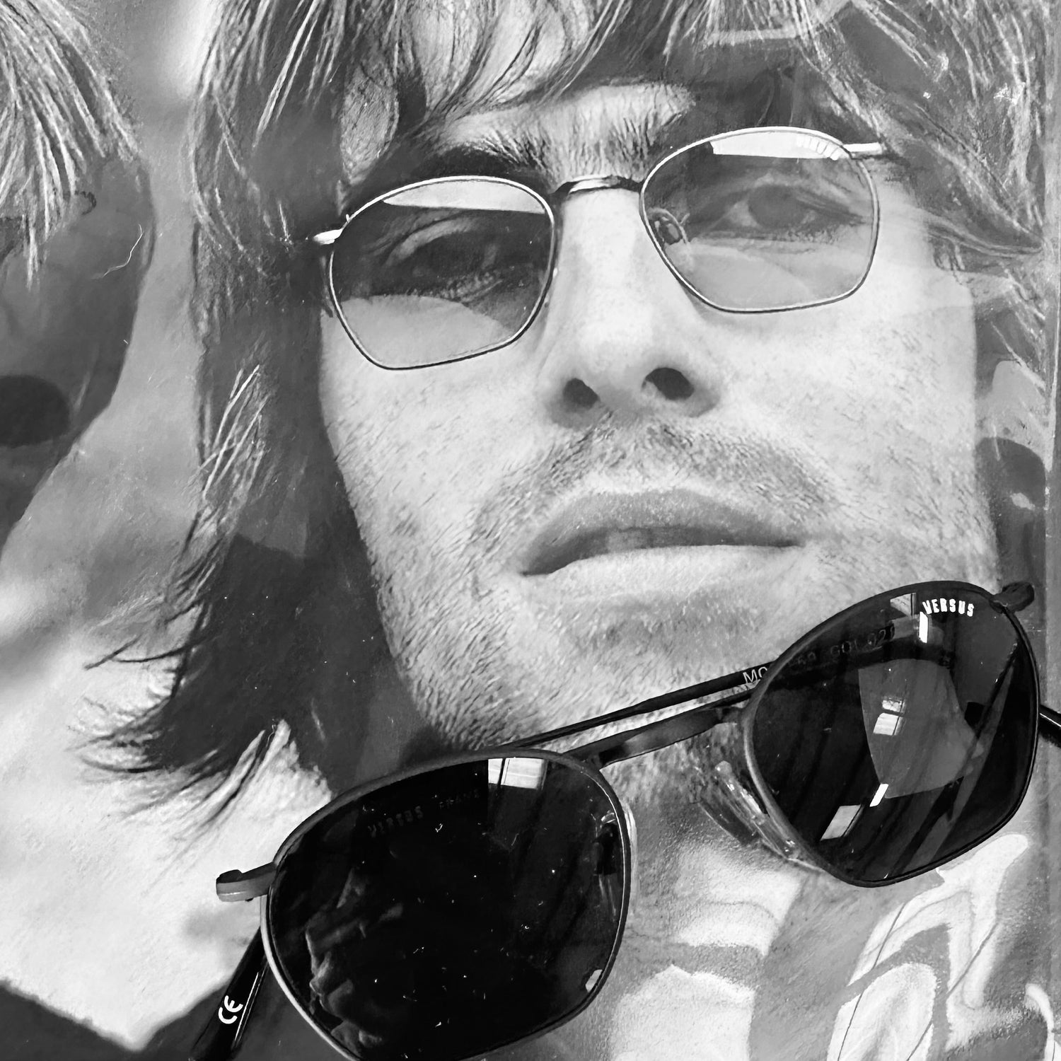 liam gallagher wearing 90s versace versus sunglasses
