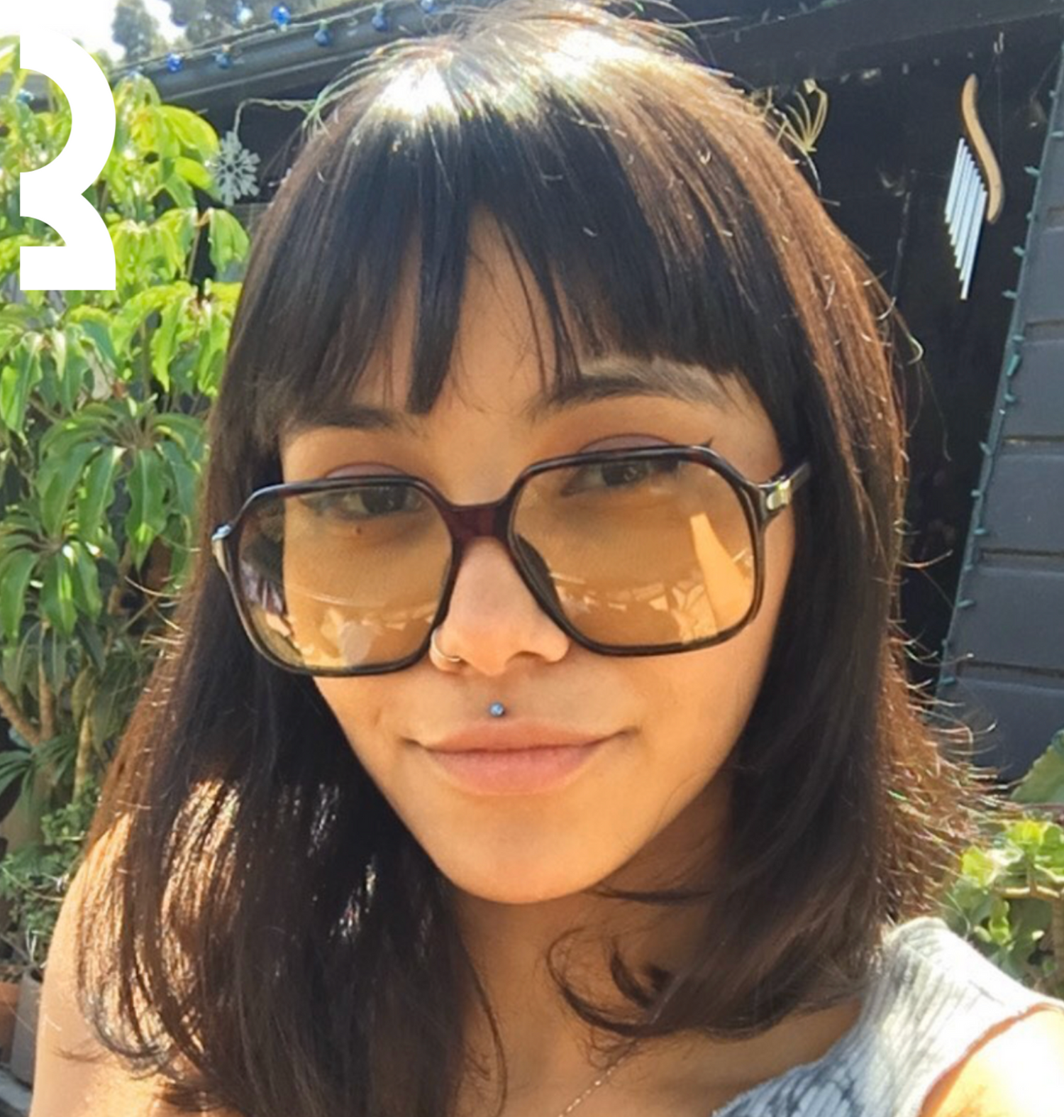 Model wearing trendy coloured lens sunglasses, showcasing the current fashion tint trend.