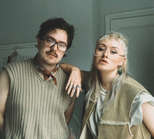 A curated flat lay of authentic vintage glasses and sunglasses from the 1950s to 1990s — original designer eyewear restored by Retro Spectacle UK.