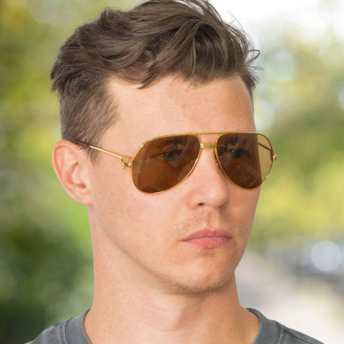 A collection of authentic vintage Cartier sunglasses, including gold-plated aviators and rimless luxury eyewear handcrafted with timeless precision.