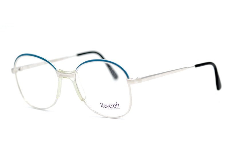 Anita Raycroft women's 70s vintage glasses. Silver metal frames with blue trim.