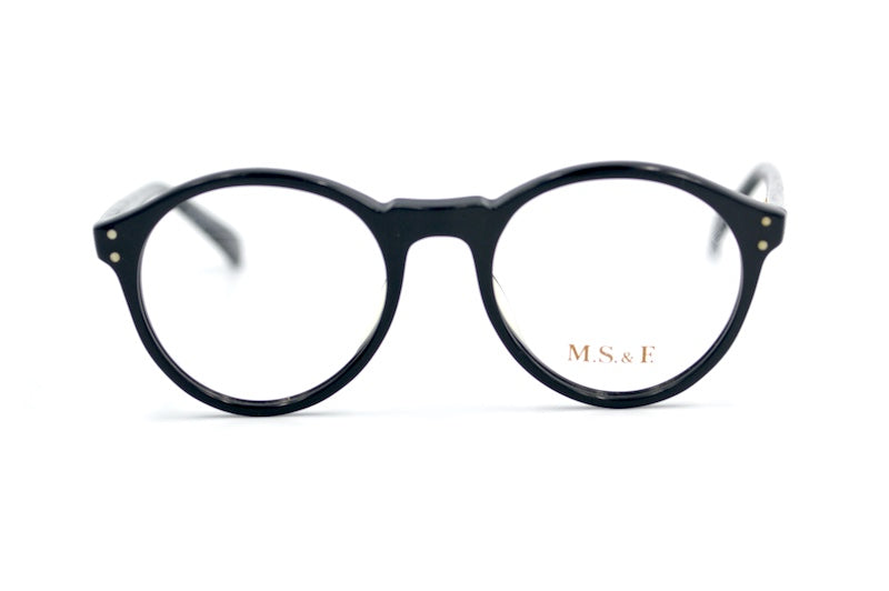 M.S. & F. 40s style round black glasses with rivet detail. 
