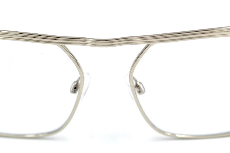 Close-up of Retro Spectacle Mod 1 silver glasses showing distinctive layered metal brow bar and bridge